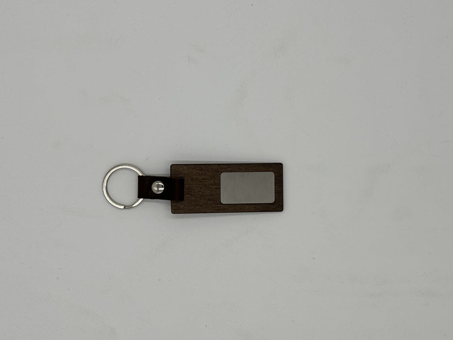 <tc>Key ring</tc> with leather strap and metal plate 7x3 cm